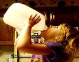 a photo of a girl drinking milke from a gallon jug a natural source of taurine