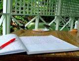 a notebook opened on a table on an outside table