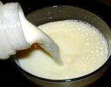a photo of white milk being poured into a glass