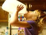 photo of a little girl drinking milk out of a gallon jug a natural source of Lysine 