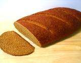 a photo of a loaf of rye bread being sliced a natural source of biotin