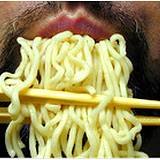 closeup of man eating pasta