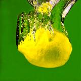 a lemon falling through a fresh stream of water