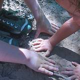 photo of children playing in the dirt in danger of needing a parasite cleanse